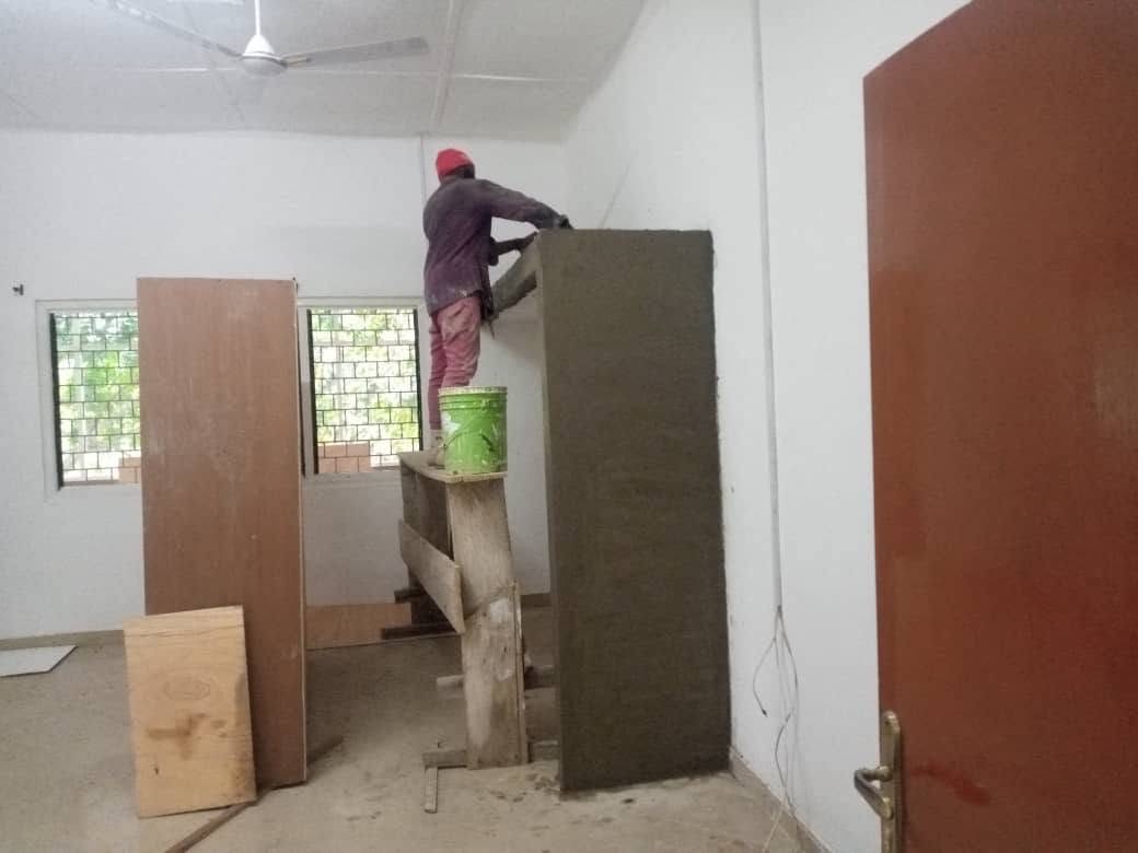X-Mell worker rendering and protecting a wall surface during interior finishing works